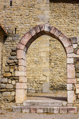 Vertical photo of a stone arch in a medieval church