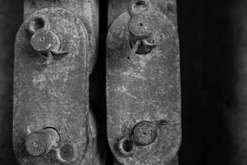Unsaturated vertical photo of old rusty iron pieces linked together