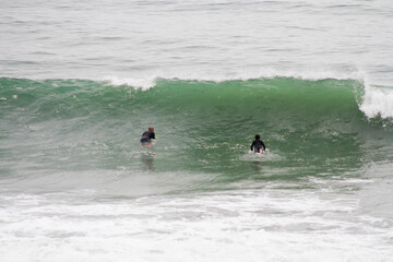 Father and son sharing surf session in Les Landes France