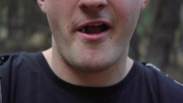 man chewing gum close up