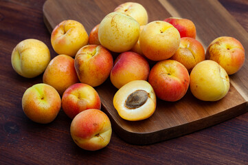 Naklejka na ściany i meble Delicious ripe apricots fruit on wooden surface close up