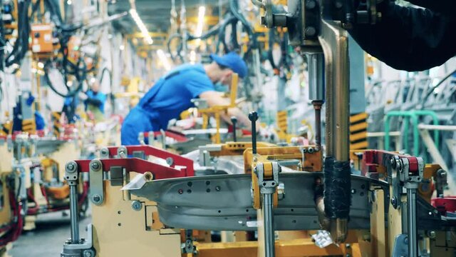 Spot welding of car part held in the car-making factory. Automobile factory, car production, auto production line.