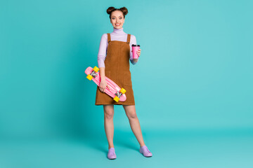 Full length photo of cute nice pretty two lovely buns hairdo youngster lady skater buy mug coffee way college wear fall brown dress violet sweater footwear isolated turquoise color background