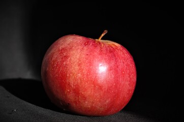 red apple on black background