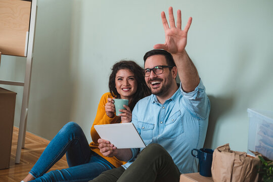 Smiling couple using tablet together at home stock photo