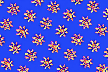 Psychedelic ribbon bow pattern on royal blue background. Vivid design composition for wrapping paper, Christmas, birthday or greetings card.