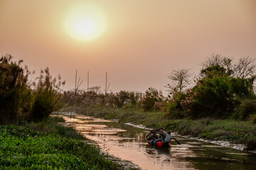 Fototapeta premium Early morning picture of small river where people catch fish