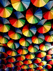 Fototapeta na wymiar Background from many multi-colored umbrellas.