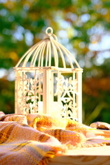 tea, coffee in a mug on the table in the garden, a candle is burning in a candlestick, the concept of outdoor tea drinking, good weather, a cozy autumn mood