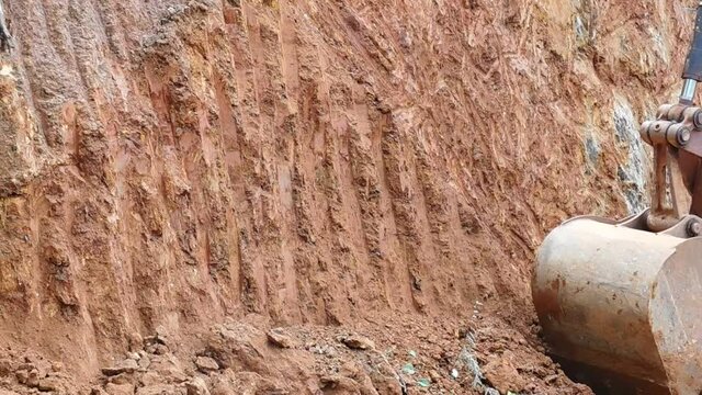 closeup of an earth mover (JCB) working on the earth surface