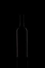Wine bottle silhouette isolated on dark background.