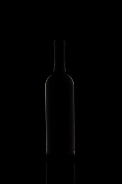 Wine bottle silhouette isolated on dark background.