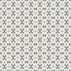 Abstract lattice pattern with dots and quatrefoil shapes.