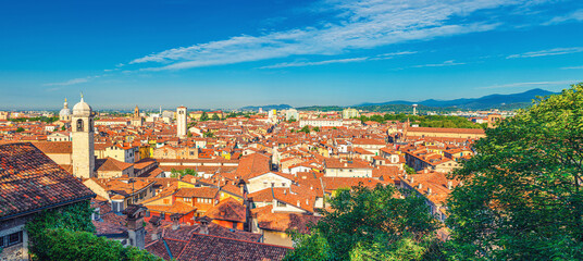 Fototapeta na wymiar Aerial panoramic view of old historical city centre of Brescia city with churches, towers and medieval buildings with red tiled roofs, Lombardy, Northern Italy. Cityscape of Brescia town.