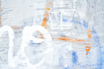 The wall is covered with old peeling plaster, painted in different colors.Backgrounds and textures.