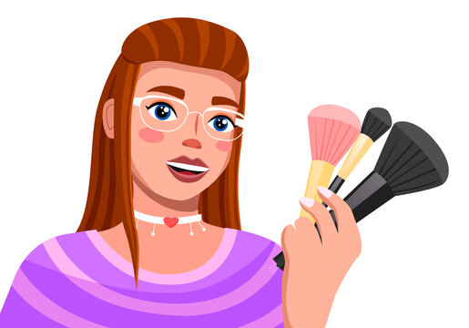 Young brown haired girl in glamour glasses talks about make-up brushes. Modern trendy girl with cosmetic accessories in hand. Woman with fashionable make-up and a choker on her neck. Blooger, streamer