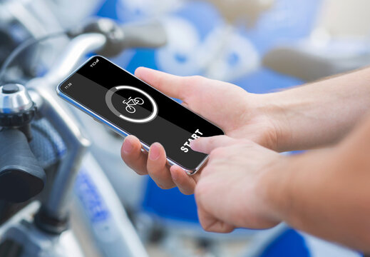 Smart bicycle travel, gadgets and activity control. Male hands press start of button on smartphone - Powered by Adobe