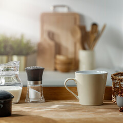 A wooden table in the kitchen on a sunny morning and sharp rays of the sun shining through the window