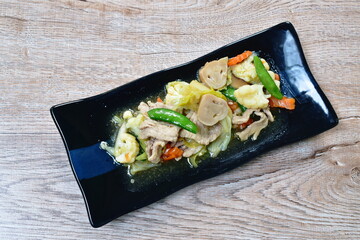 fried mixed vegetable with slice pork with soy sauce on plate