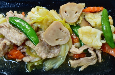 fried mixed vegetable with slice pork with soy sauce on plate