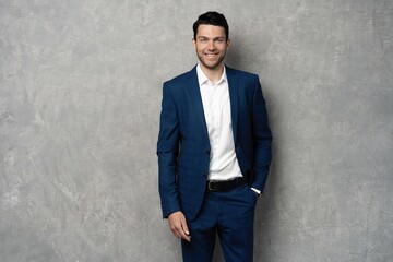 Handsome man wear blue suit isolated on grey background