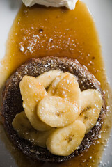 Banana Fosters Dessert. Classic American or French bakeries or pastry shop favorites. Cookies, whipped cream, cakes, chocolate syrup butter, eggs and vanilla beans.