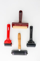 Collection of rubber brayers use in craft process on white background in top view.