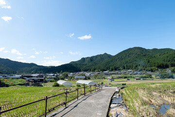 Fototapeta na wymiar A view of an agricultural village deep in the mountains of Japan, taken on a clear day