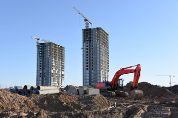 Excavator working at construction site. Backhoe on road work and earthworks. Earth-Moving Heavy...