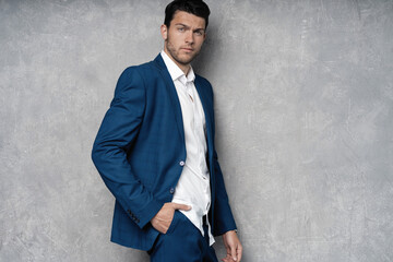 Handsome man wear blue suit isolated on grey background