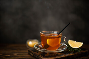 hot black tea with honey and lemon in a glass mug