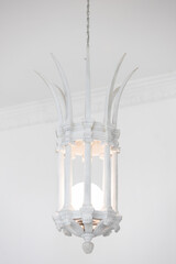 close up view of white vintage stone lantern or lamp hanging from ceiling