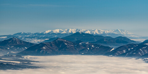 Tatra mountains with nearer Velka Fatra mountains and Velky Choc hill feom Velka luka hill in winter Mala Fatra mountains in Slovakia