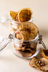 Subtle Fruit Chips in a Glass Jars Orange and Apple Chips Yellow Background Vertical