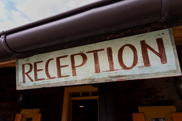 Reception sign made of wood at the Hotel entrance