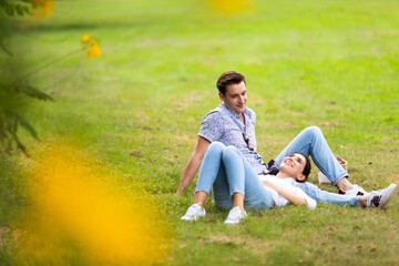 Romantic couple in love concept. Young happy couple enjoying picnic on a holiday at the park