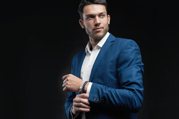 Handsome man wear blue suit isolated on black background