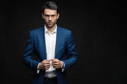 Handsome man wear blue suit isolated on black background