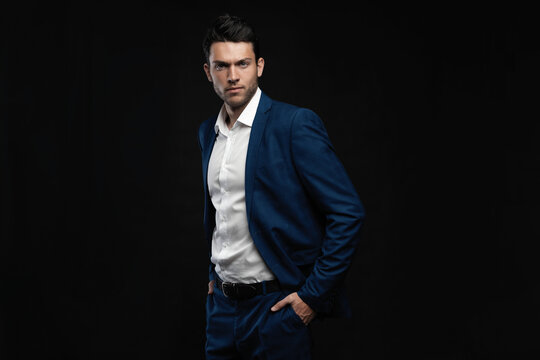 Handsome man wear blue suit isolated on black background