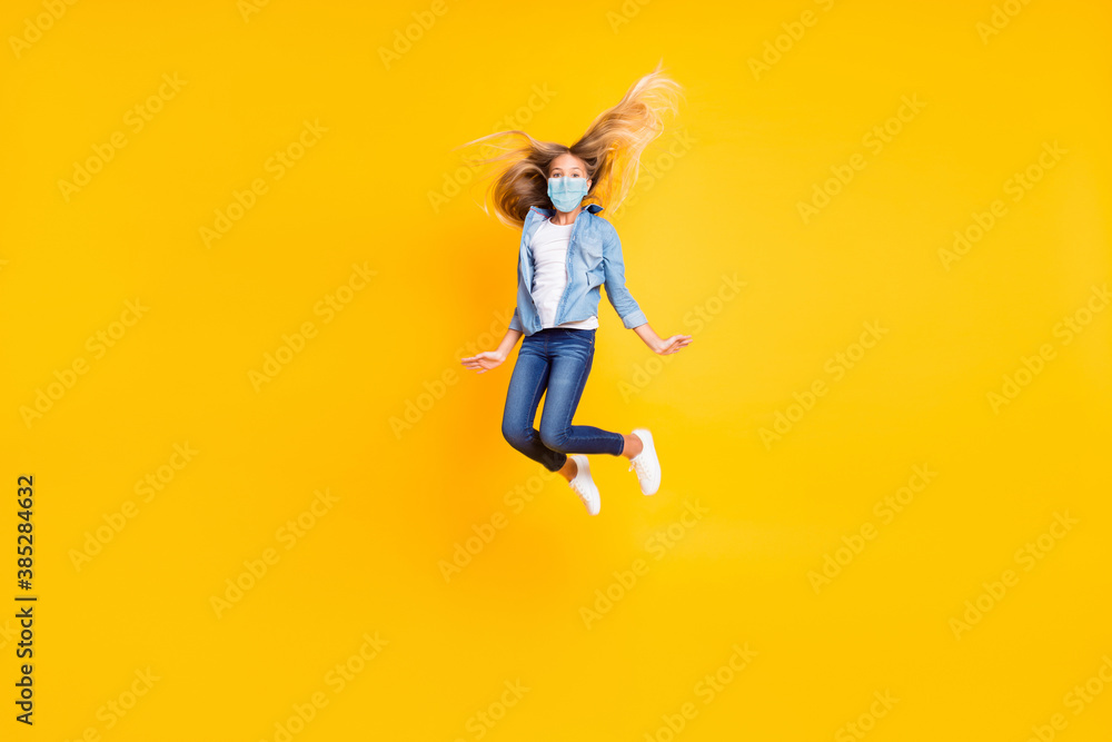 Sticker Full body size photo of girl long blonde hair jumping high wear jeans mask shirt isolated on bright yellow color background