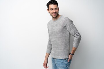 Handsome young man on white background looking at camera. Happy guy smiling.