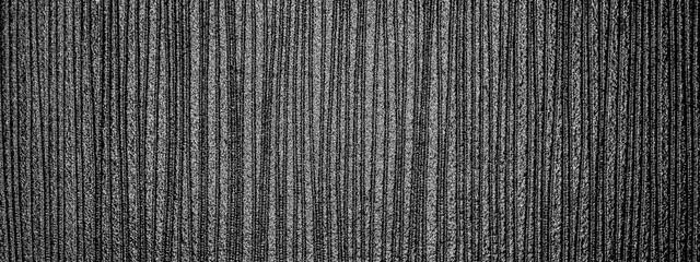 Small furrows on the monochrome graphite surface. The luster of graphite.