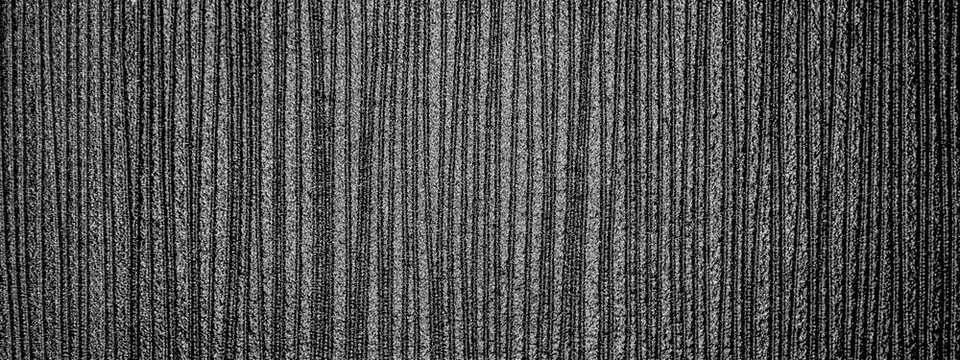 Small furrows on the monochrome graphite surface. The luster of graphite.
