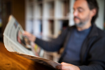 Mann liest zuhause Zeitung