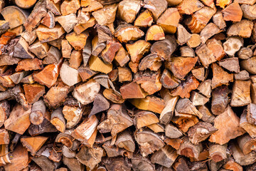 Christmas texture background of dry wooden log cabins. Woodpile of cut Lumber for forestry industry