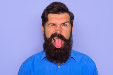 Obraz premium Man shows tongue. People emotions. Face expression. Fanny man.