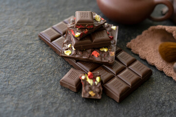 Sweets and chocolate on a black background. Morning tea with chocolate cake
