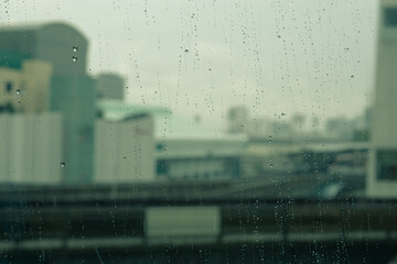 Rain on the window with city view