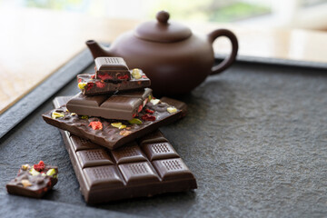 Sweets and chocolate on a black background. Morning tea with chocolate cake