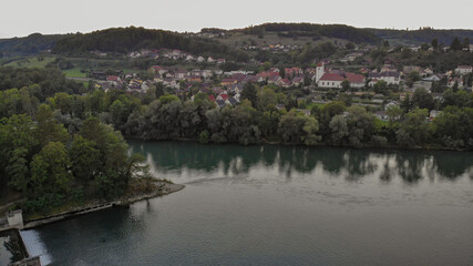 Aerial view over Aare river, to the church and residential area of Umiken and Riniken, Switzerland.